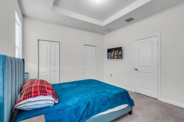 a bedroom with a bed and a couch