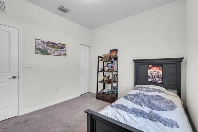a bedroom with a bed and a book shelf