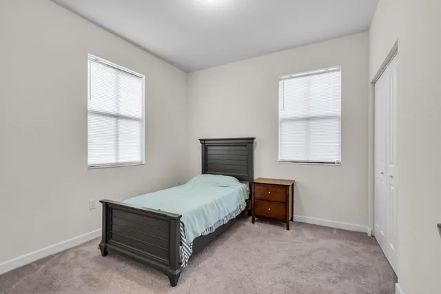 a bedroom with a bed and window