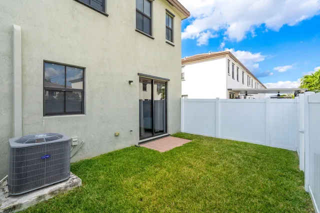 a view of a backyard with potted plants
