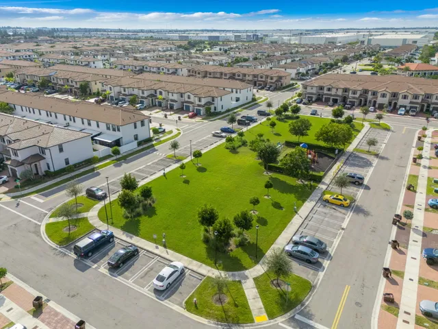 an aerial view of a swimming pool with a yard