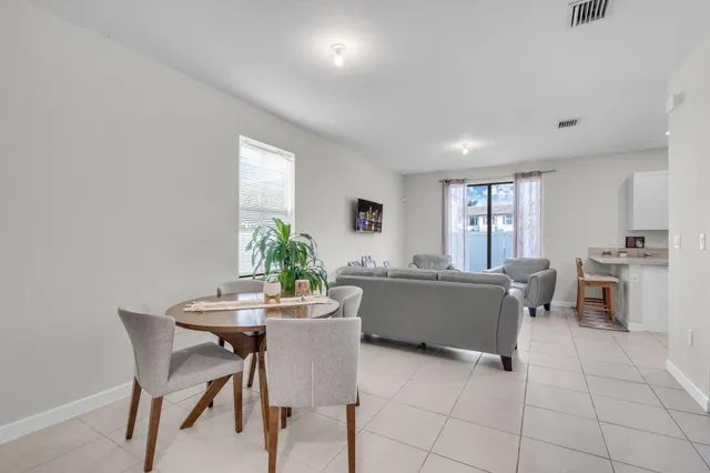 a view of a dining room with furniture and window
