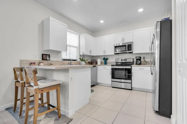 a kitchen with stainless steel appliances a stove sink microwave and cabinets