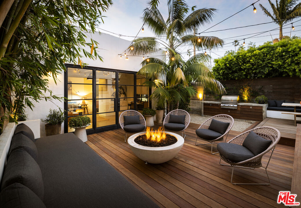 a view of a patio with couches chairs and a potted plant