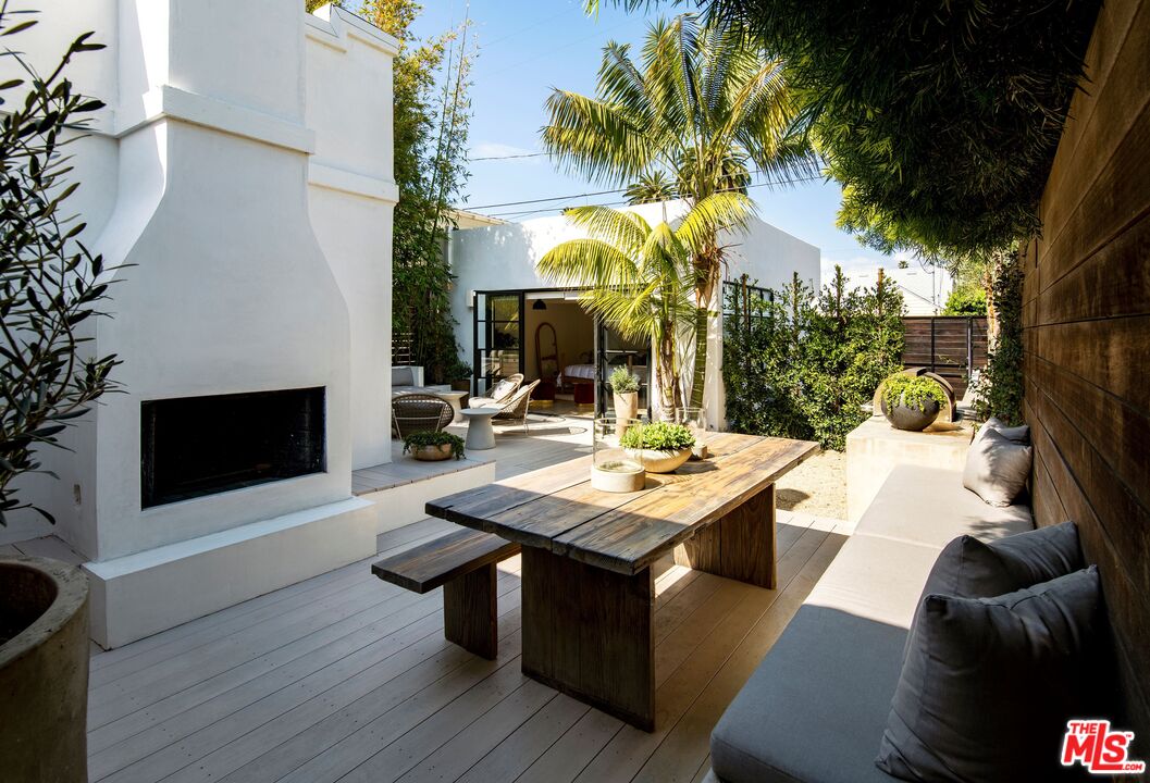 817 Crestmoore Place Venice, CA 90291 - Photo 14 of 22 a view of a patio with table and chairs potted plants and palm tree