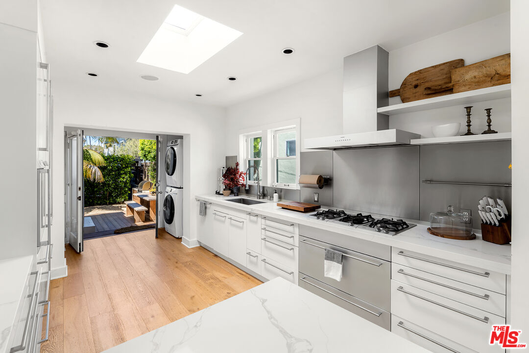 817 Crestmoore Place Venice, CA 90291 - Photo 7 of 22 a kitchen with stainless steel appliances a stove a sink and white cabinets