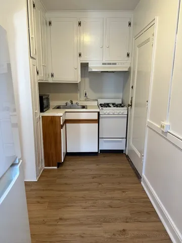 a kitchen with stainless steel appliances granite countertop a stove and a refrigerator