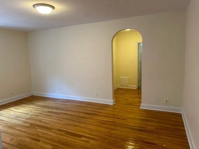 a view of a room with wooden floor and a sink