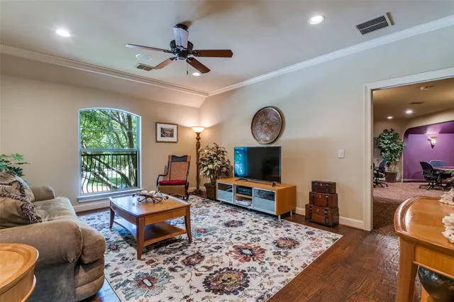 a living room with furniture a window and a flat screen tv
