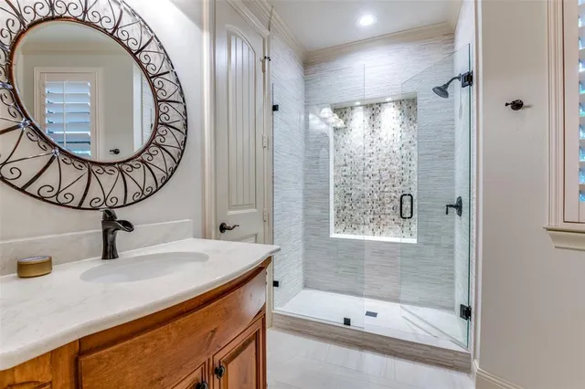 a bathroom with a sink a mirror and a shower