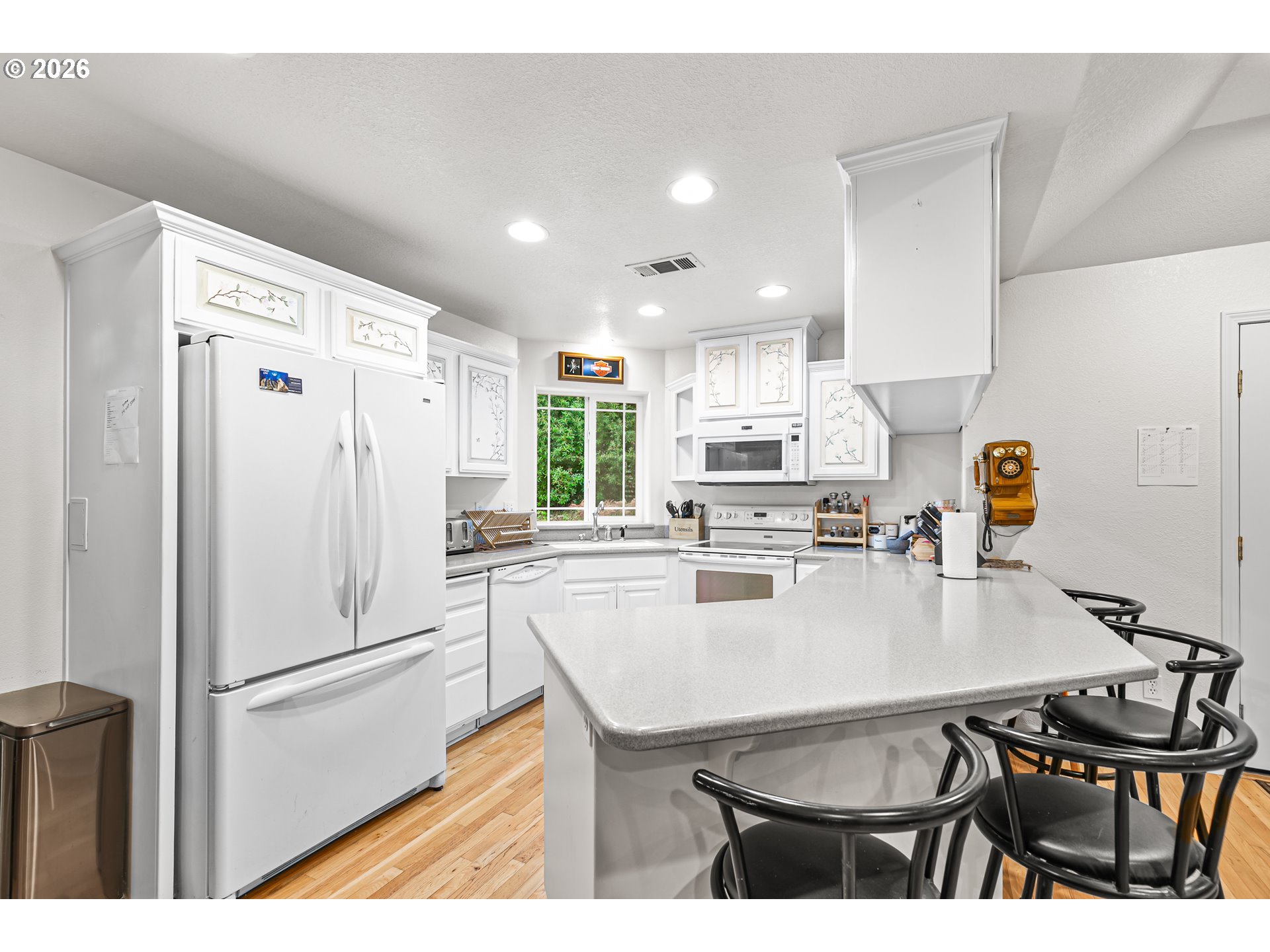 419 Idlewild Drive Cave Junction, OR 97523 - Photo 17 of 47 a kitchen with stainless steel appliances a refrigerator a sink a stove a dining table and chairs