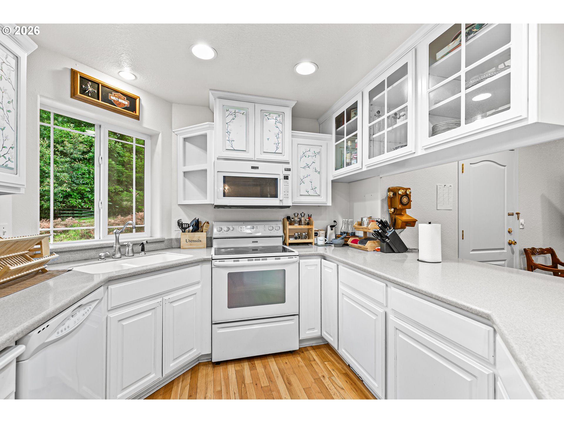 419 Idlewild Drive Cave Junction, OR 97523 - Photo 19 of 47 a kitchen with stainless steel appliances a sink a stove a window and cabinets