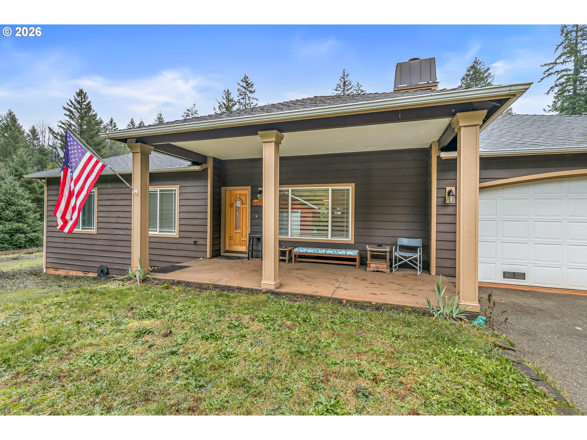 419 Idlewild Drive Cave Junction, OR 97523 - Photo 32 of 47 a view of a house with a porch and a yard