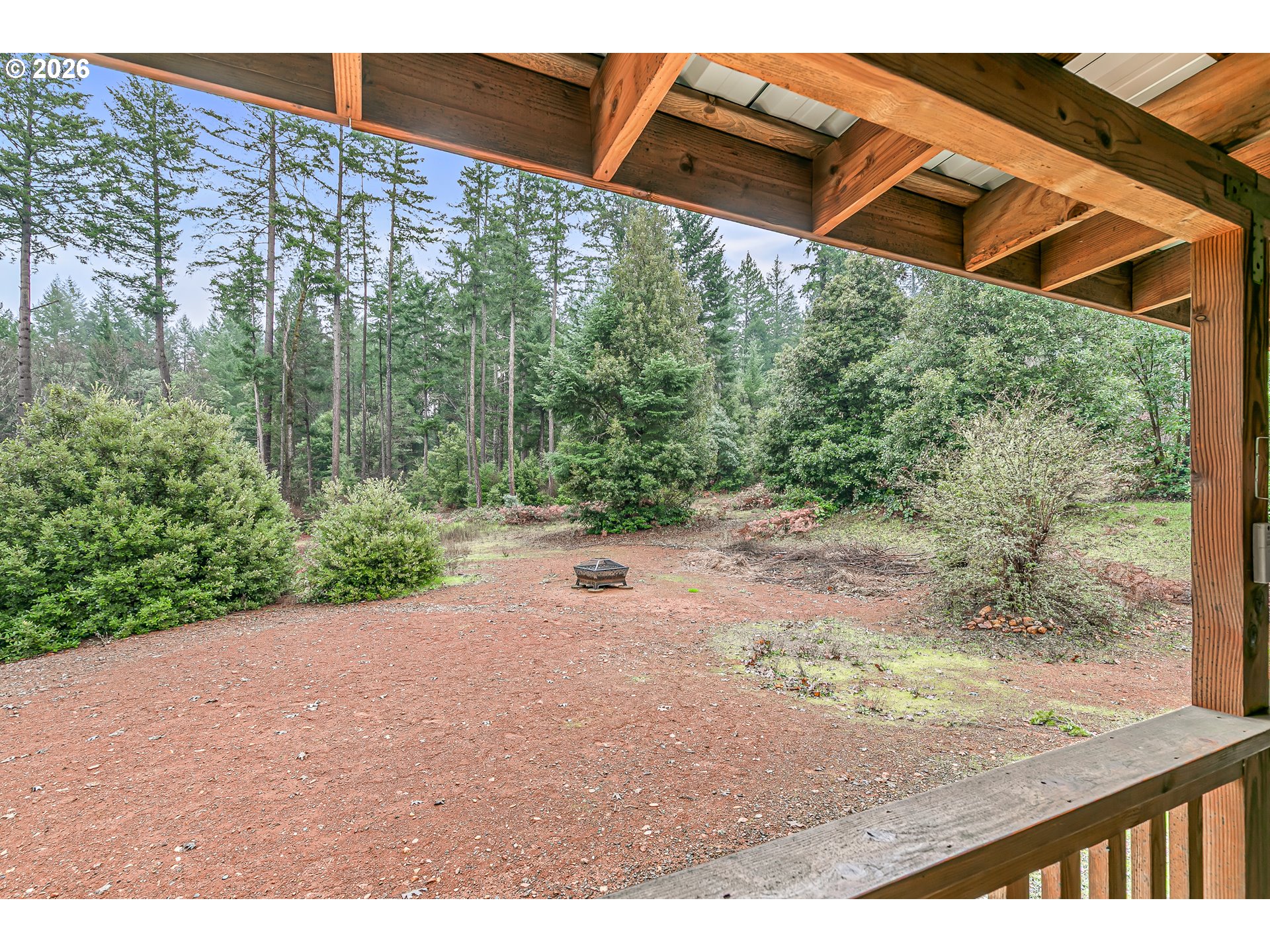 419 Idlewild Drive Cave Junction, OR 97523 - Photo 39 of 47 a view of a backyard with floor to ceiling window and wooden floor