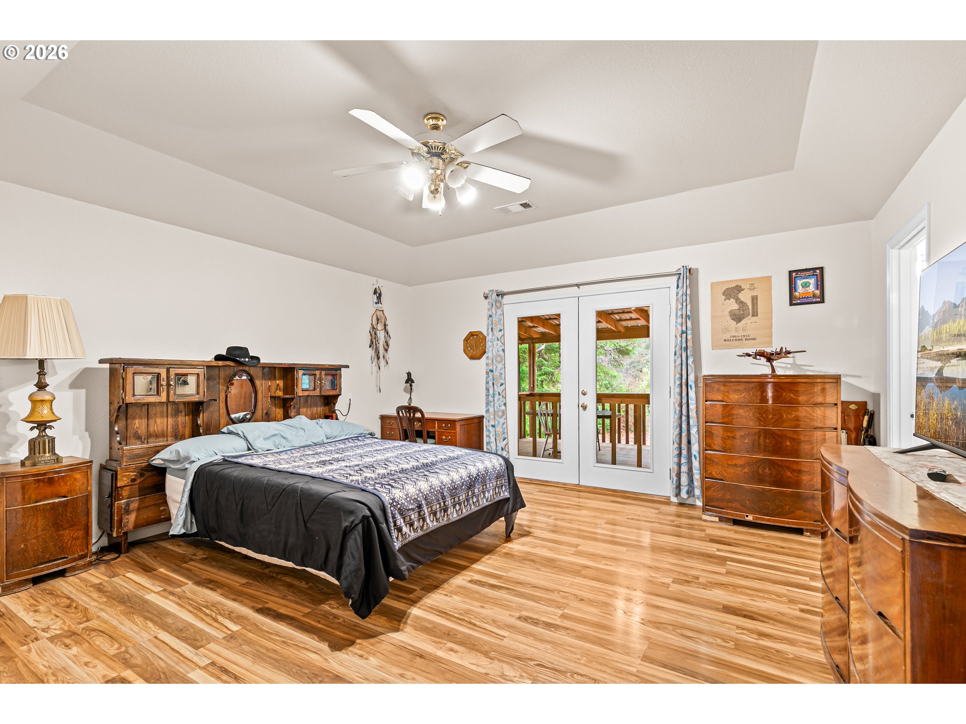 419 Idlewild Drive Cave Junction, OR 97523 - Photo 4 of 47 a bedroom with a large bed and a chandelier