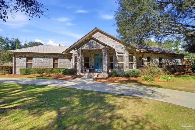 a view of a house with swimming pool and sitting area