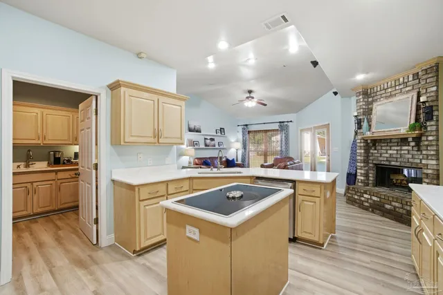a kitchen with a stove sink and cabinets