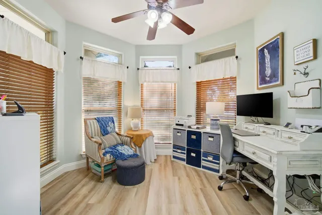 a dining room with furniture windows and wooden floor