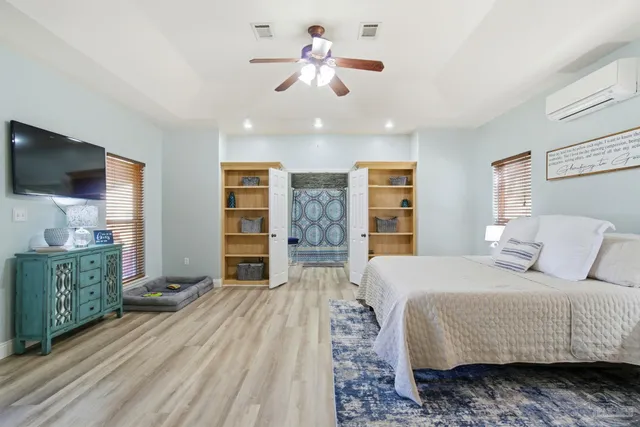 a bedroom with a bed and a chandelier