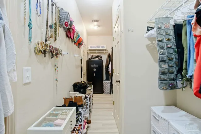 a bedroom with a bed and a wooden floor