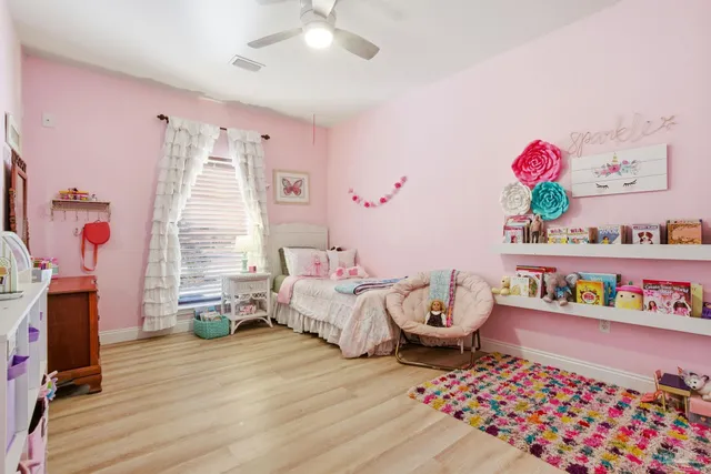 a white toilet sitting next to a bathroom sink and vanity