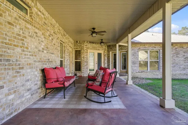 a view of a house with backyard and sitting area