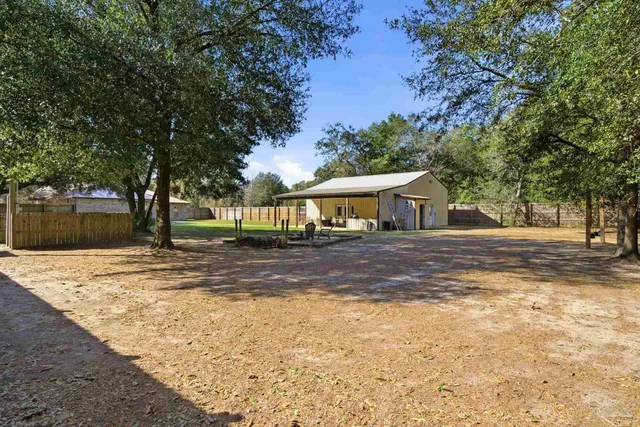 a living room with furniture hard wood floor and a ceiling fan