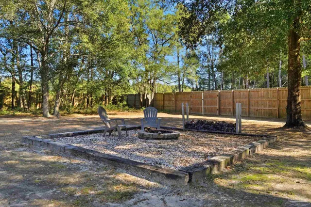 a view of a workspace with furniture and wooden floor
