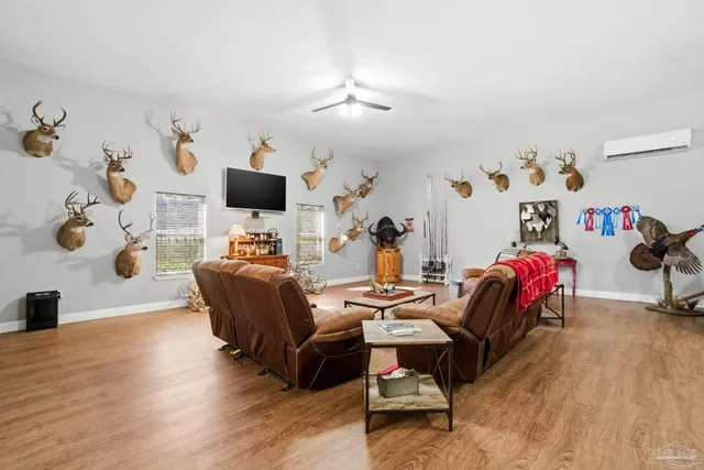 a view of a swimming pool with lawn chairs and plants