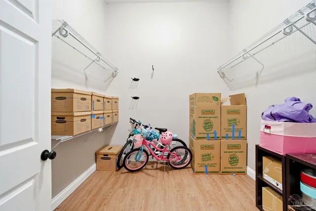an aerial view of a house with swimming pool and large trees