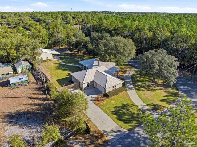 a aerial view of a house with a yard and lake view