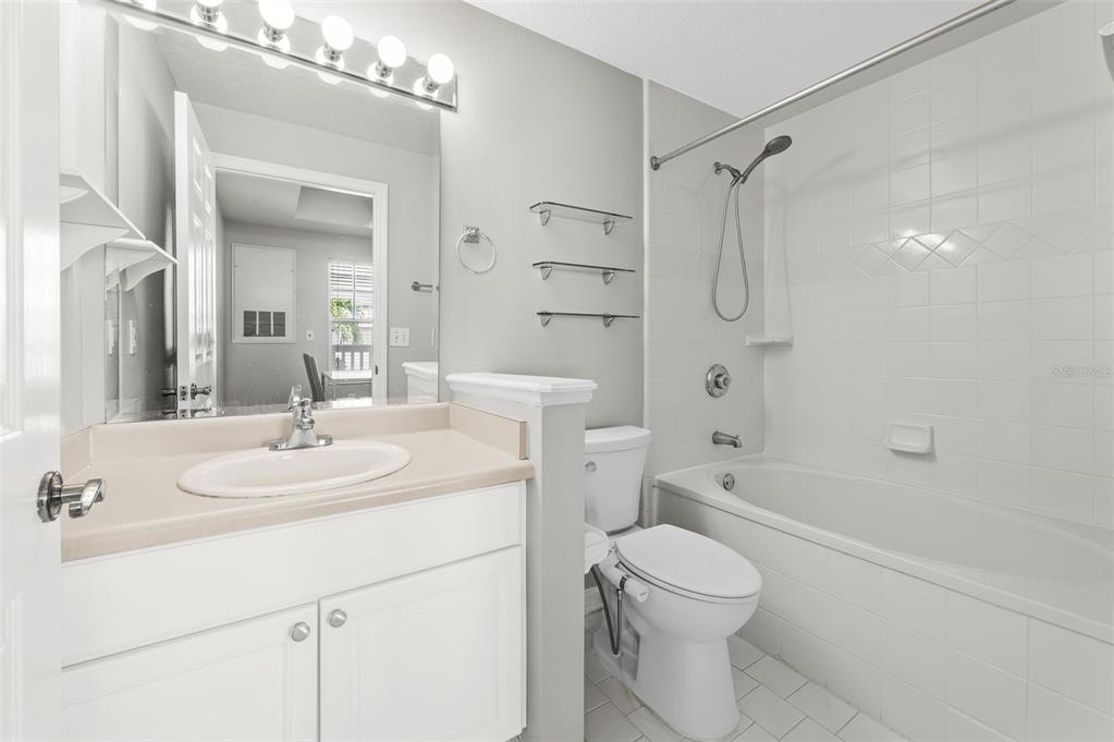 800 South Dakota Avenue, Unit 330 Tampa, FL 33606 - Photo 11 of 25 a bathroom with a sink toilet vanity and shower