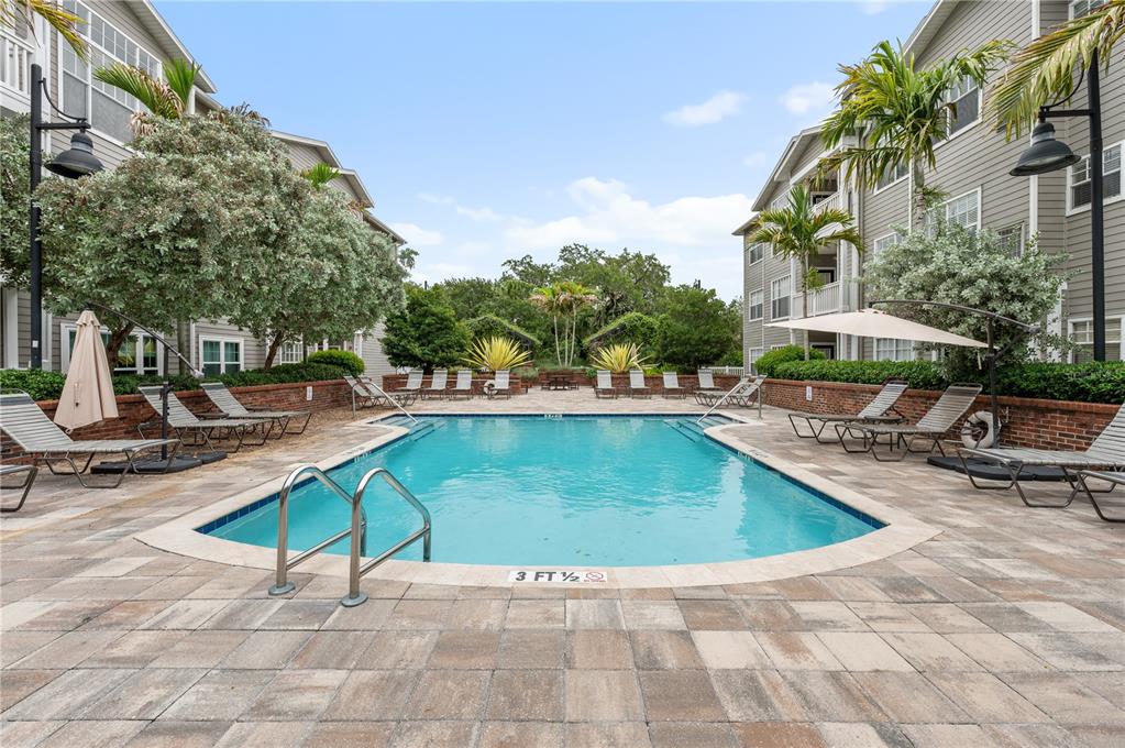 800 South Dakota Avenue, Unit 330 Tampa, FL 33606 - Photo 13 of 25 a swimming pool with outdoor seating and yard