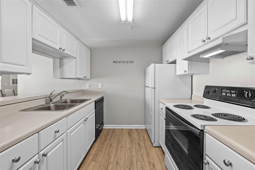 800 South Dakota Avenue, Unit 330 Tampa, FL 33606 - Photo 9 of 25 a kitchen with a sink a stove and refrigerator