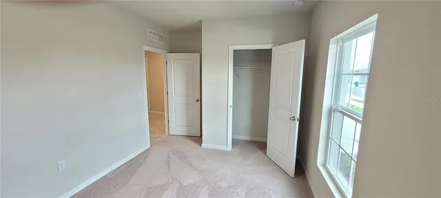 a bathroom with a granite countertop toilet sink and mirror