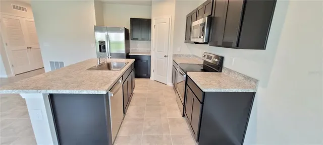 a bathroom with a granite countertop sink a mirror and vanity