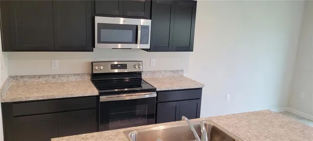 a kitchen with a stove and a microwave