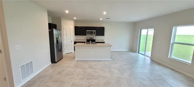 a kitchen with stainless steel appliances a refrigerator and a stove top oven