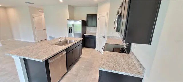 a kitchen with a sink stove and refrigerator