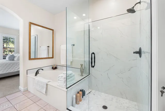 a bathroom with a tub a sink and a shower