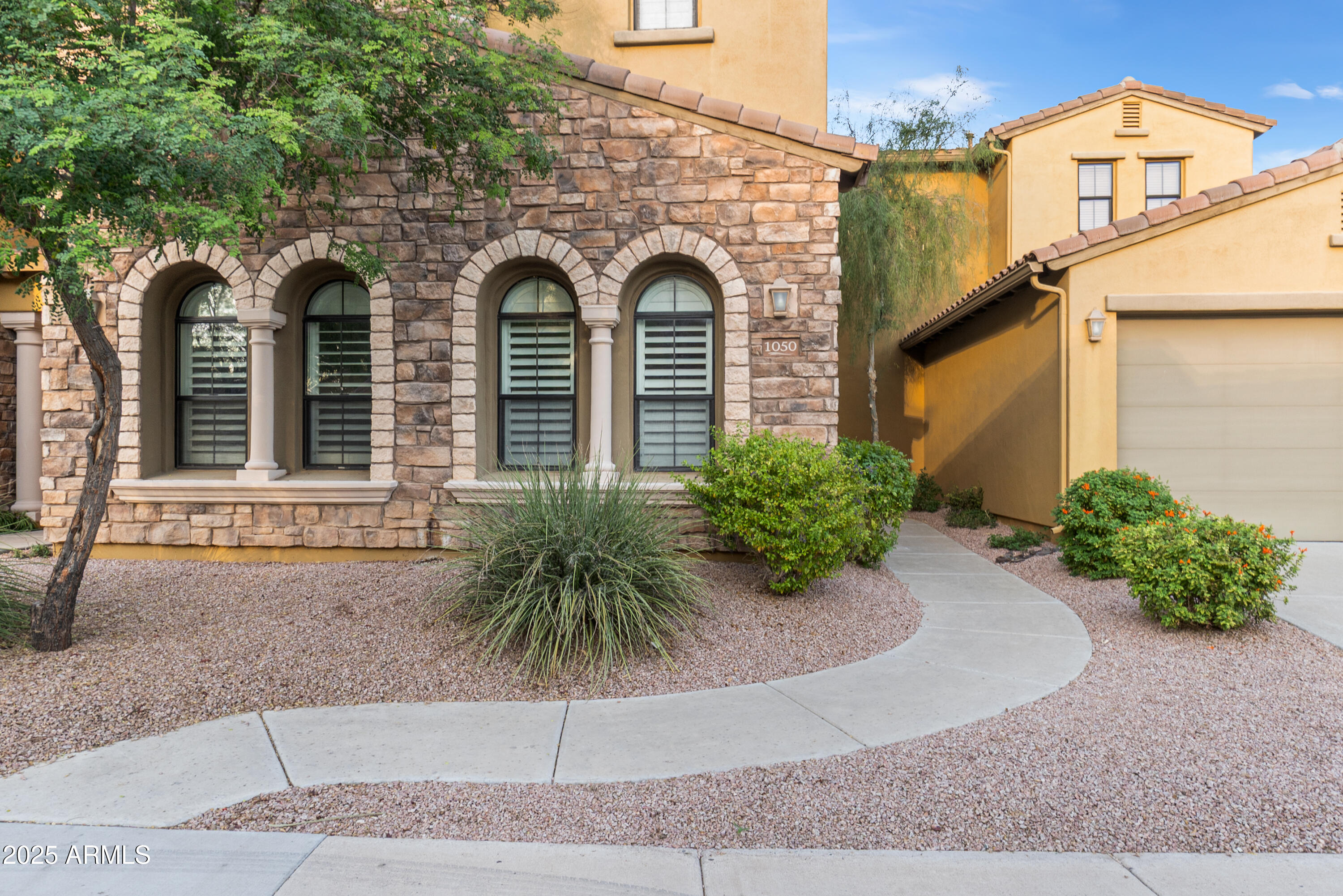 20750 North 87th Street, Unit 1050 Scottsdale, AZ 85255 - Photo 2 of 21 a front view of a house with garden