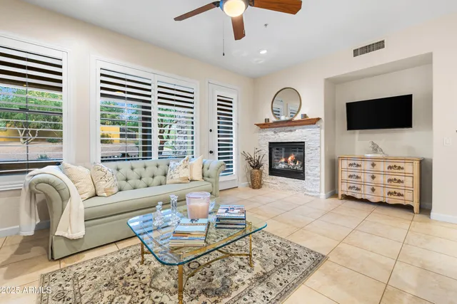 a living room with furniture a flat screen tv and a fireplace