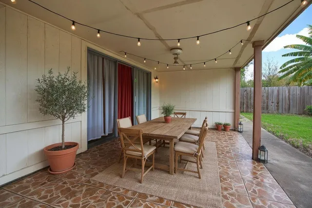 a outdoor dining space with a table and chairs