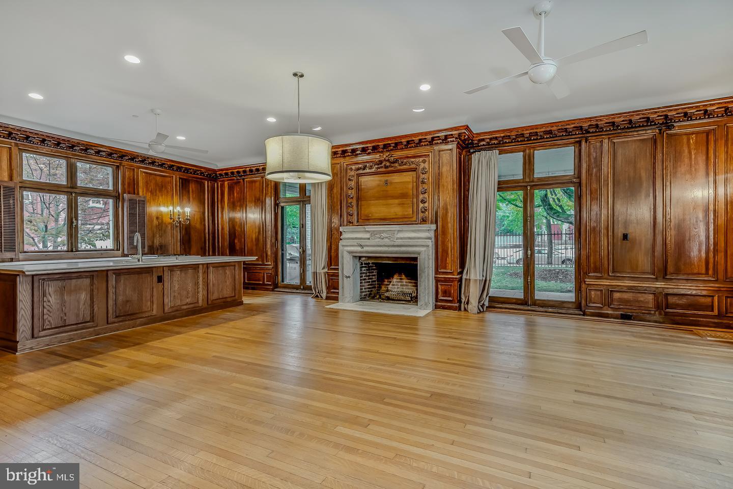 4200 Pine Street, Unit 108A Philadelphia, PA 19104 - Photo 20 of 49 an empty room with wooden floor fireplace and windows