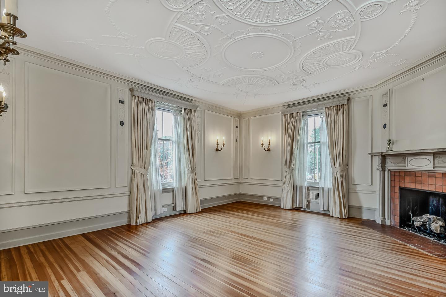 4200 Pine Street, Unit 108A Philadelphia, PA 19104 - Photo 26 of 49 an empty room with wooden floor fireplace and windows