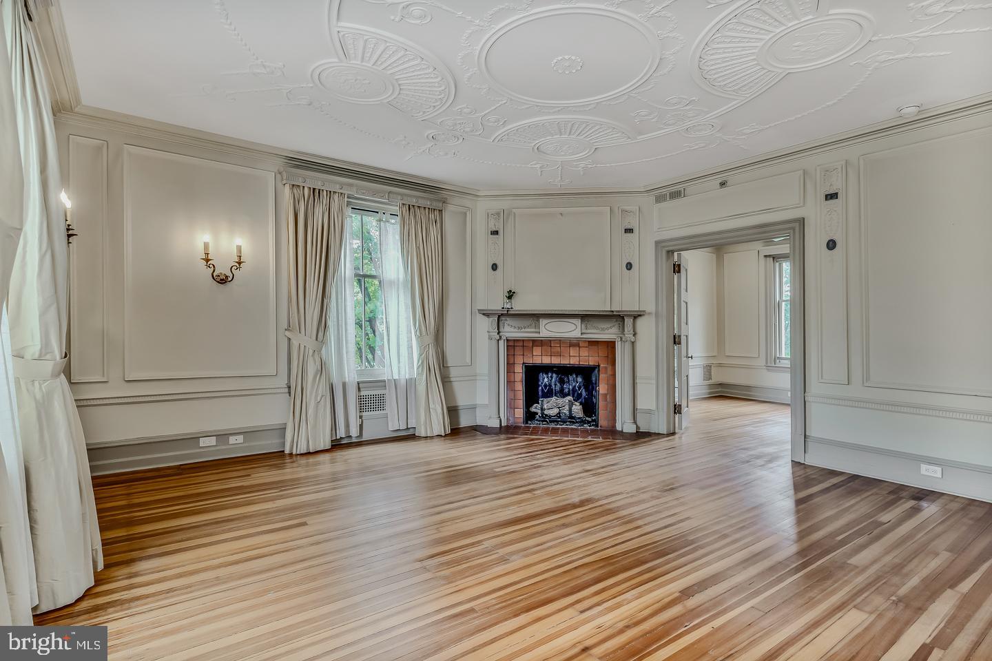 4200 Pine Street, Unit 108A Philadelphia, PA 19104 - Photo 27 of 49 a view of a livingroom with wooden floor a fireplace and window