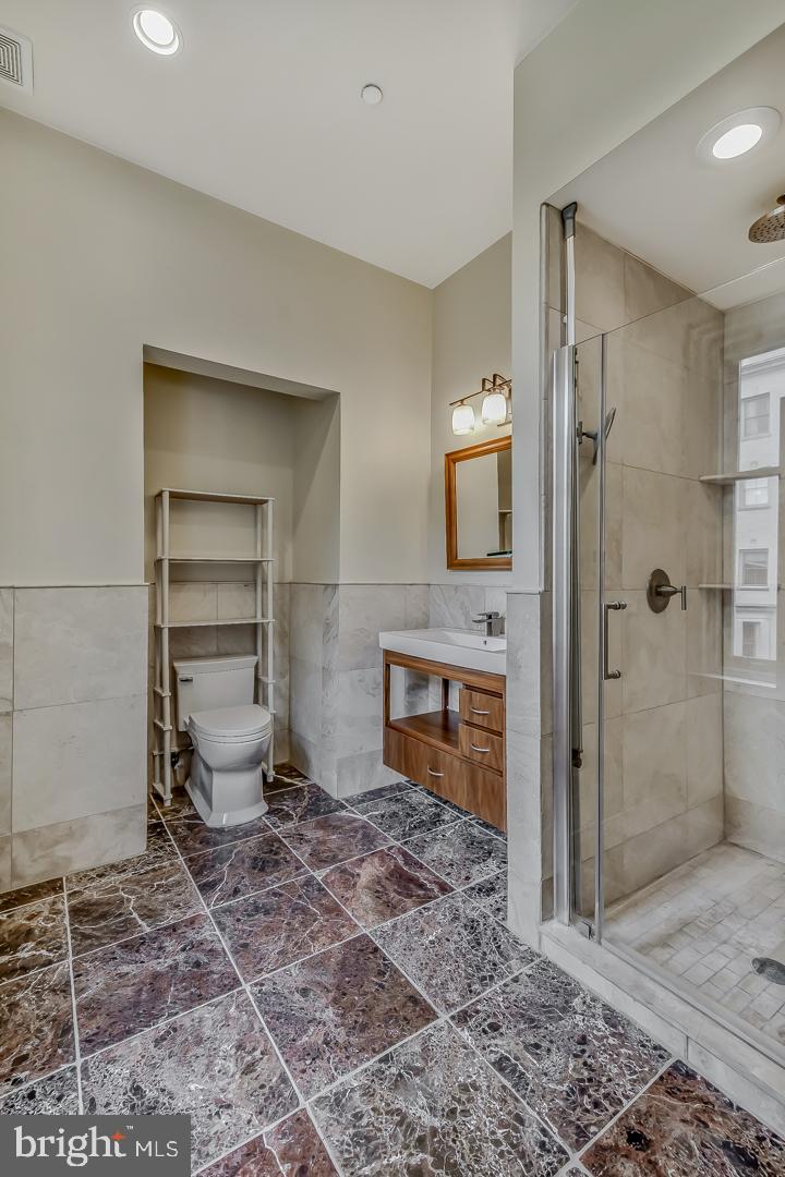 4200 Pine Street, Unit 108A Philadelphia, PA 19104 - Photo 34 of 49 a spacious bathroom with a toilet a sink and shower