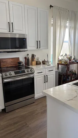a kitchen with a stove and a microwave