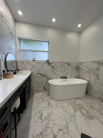 a bathroom with a bathtub and a sink
