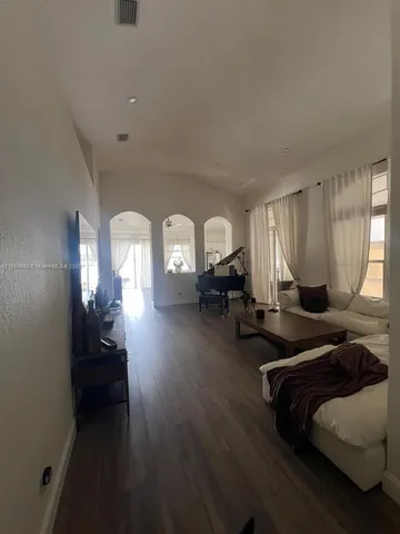 a living room with couches and furniture with wooden floor